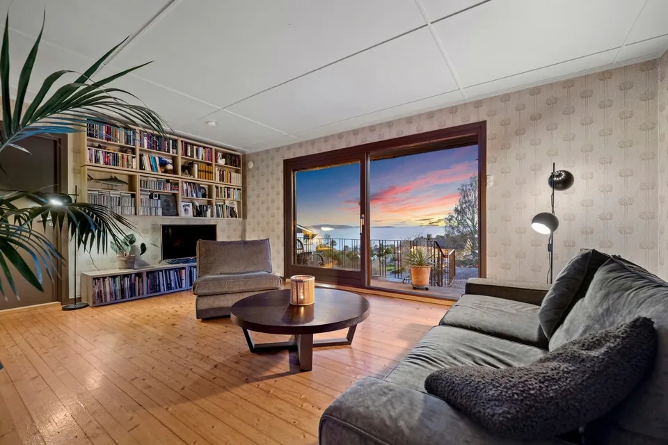 Stue med eldre parkett og tapet før renovering